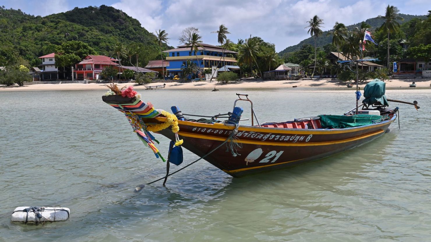 In this photo taken on August 18, 2020 a taxi boat is anchored along an empty beach in Chalok Baan Kao Bay in Koh Tao island in the Gulf of Thailand. 