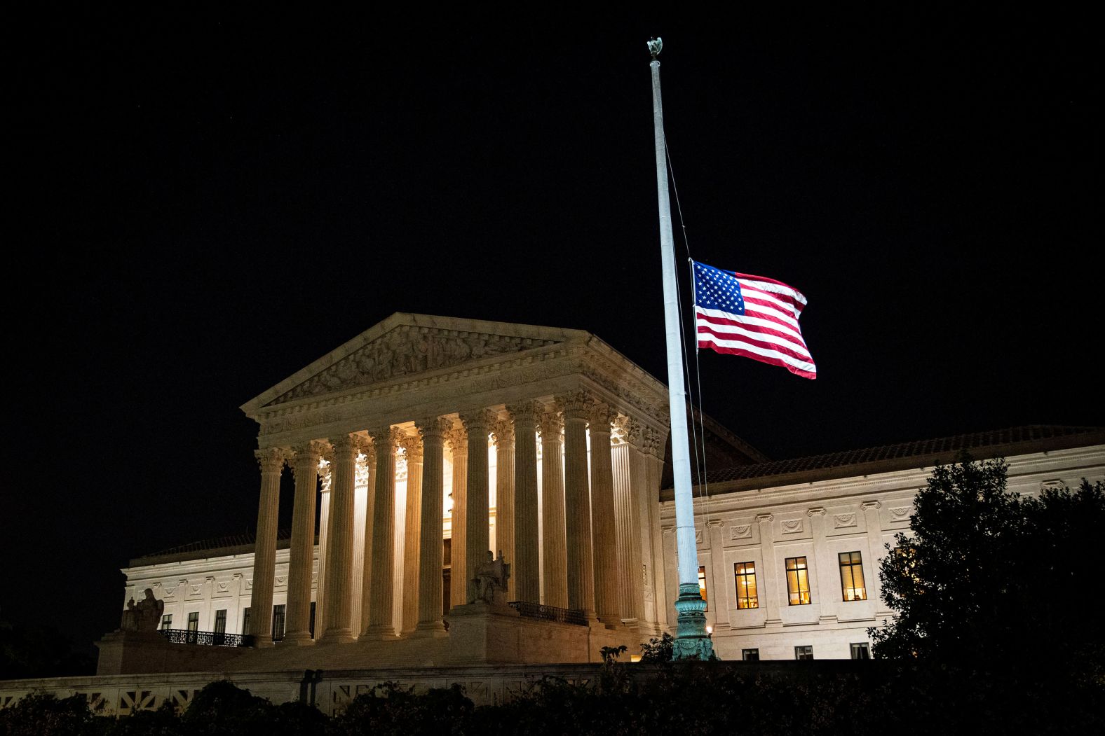 The American flag flies at half-staff outside the Supreme Court on September 18.