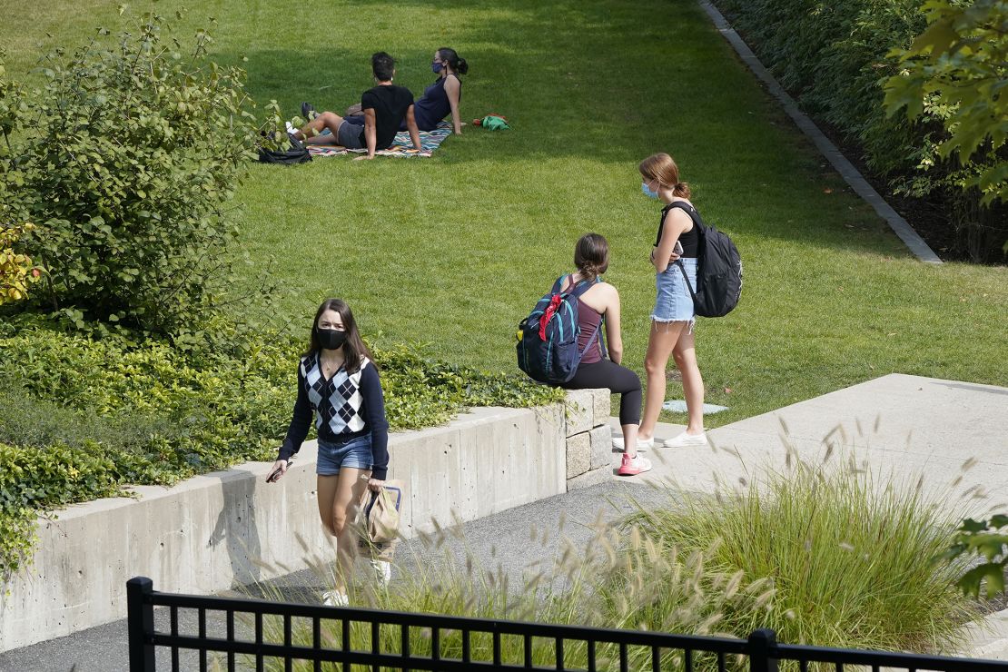 College students wear masks our of concern for the coronavirus on the Boston College campus.