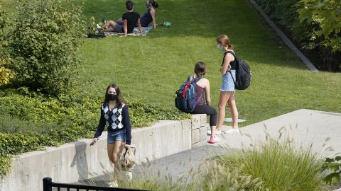 College students wear masks our of concern for the coronavirus on the Boston College campus.