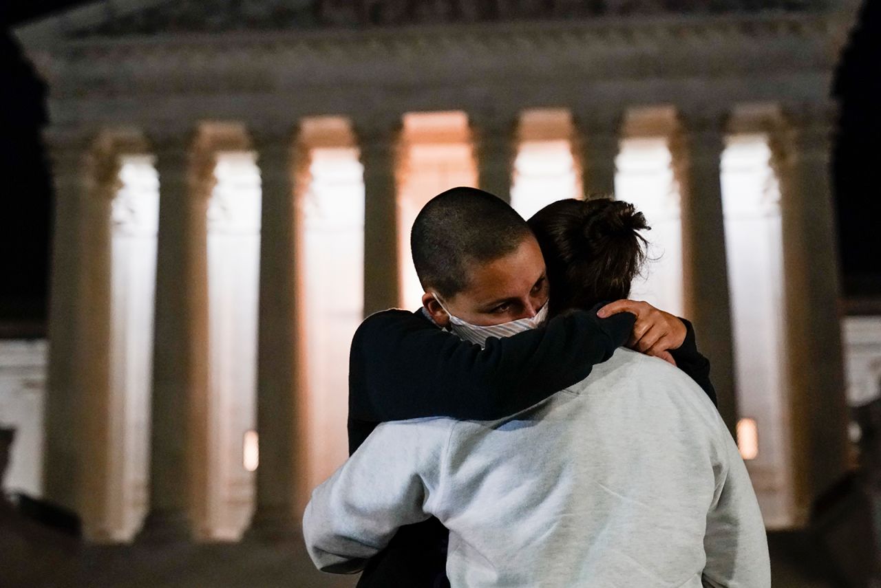 A couple hugs outside the Supreme Court on September 18.