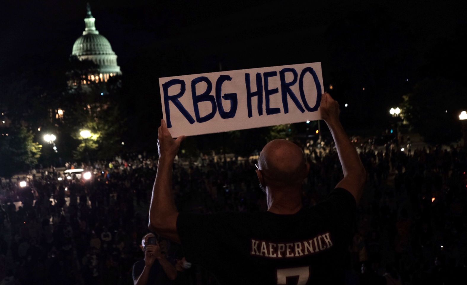 A man holds a sign on the steps of the US Supreme Court on Friday, September 18.