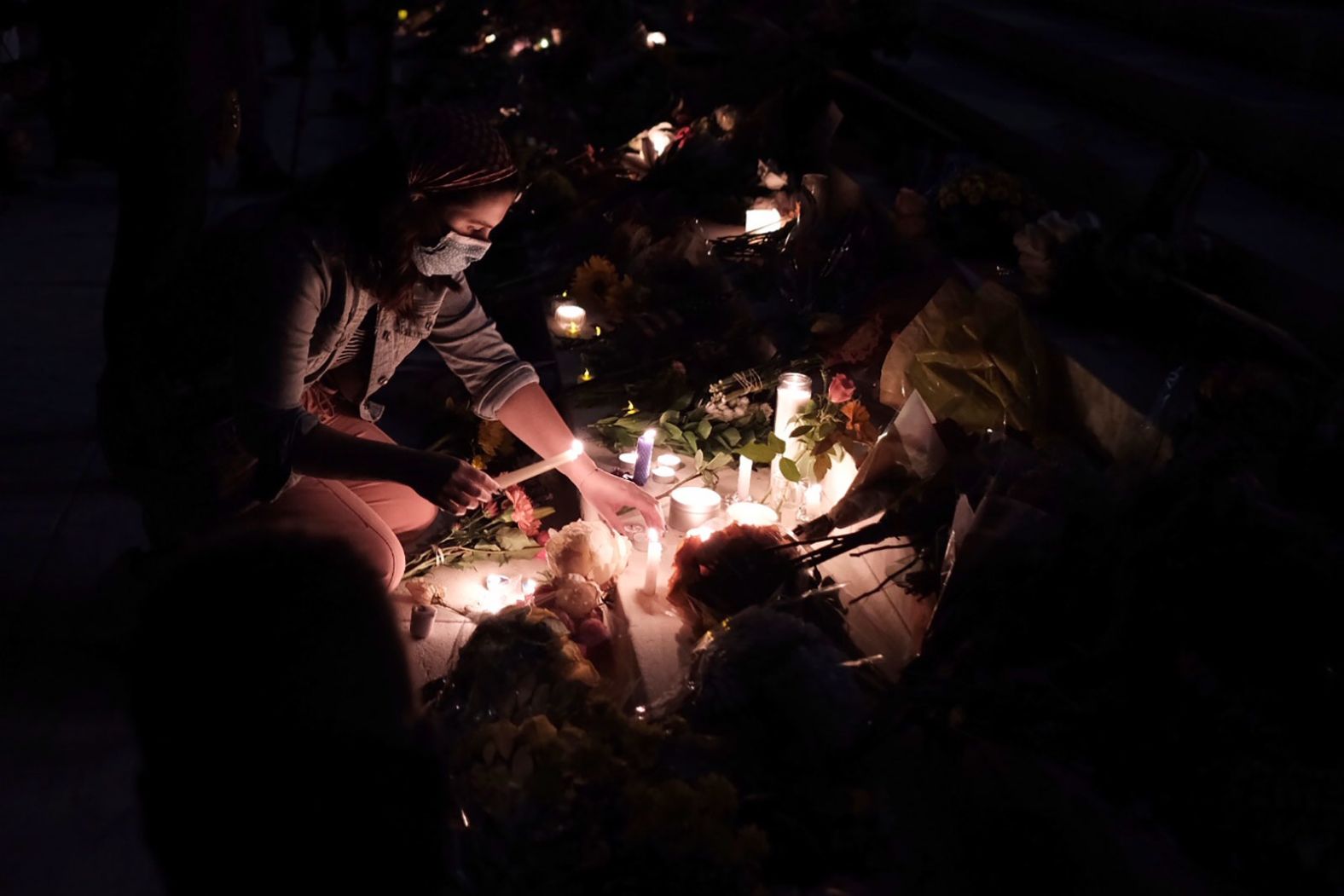 People leave flowers and candles in Washington, DC.