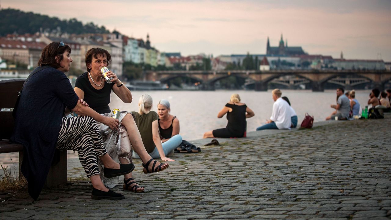 Friends gather at Vltava river bank in Prague, on September 16, as the Czech Republic recorded its highest increase in cases since the beginning of the pandemic.