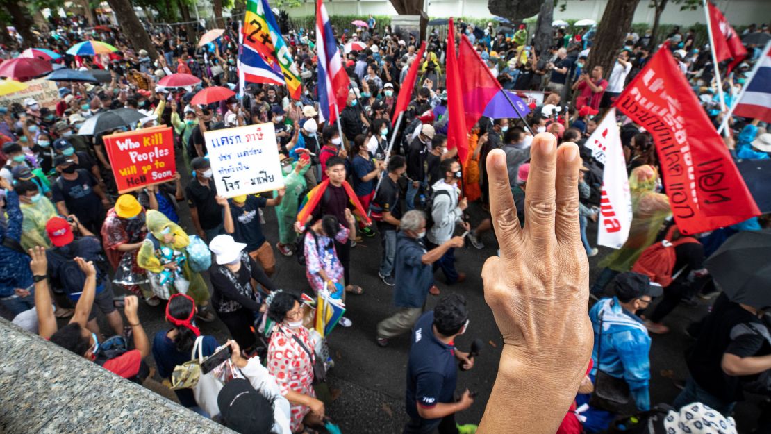 Pro-democracy protesters salute with a three-finger symbol during a protest in Bangkok, Thailand, on September 19.