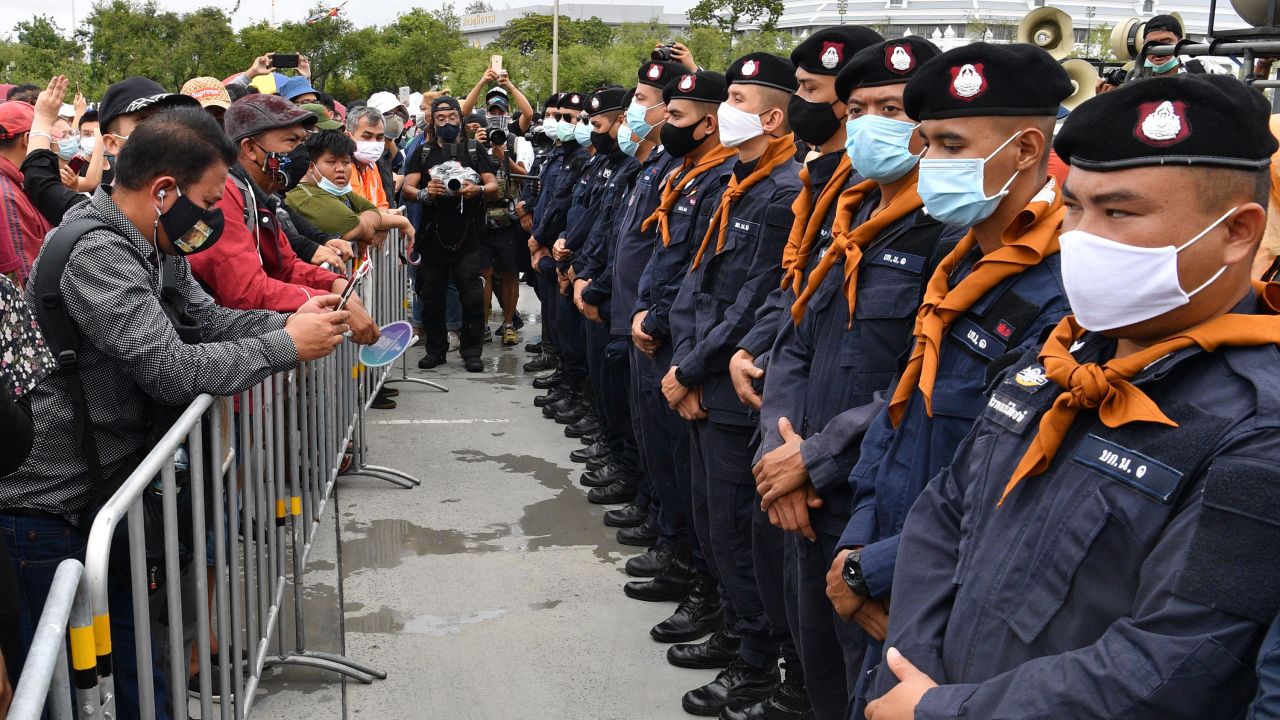 Security forces stand guard as anti-government protesters take part in a rally in Bangkok on September 19.