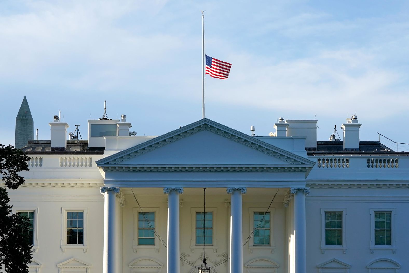 The American flag flies at half-staff over the White House on September 19.