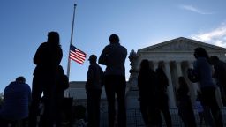 U.S. flag is seen at half mast as people gather in front of the U.S. Supreme Court following the death of U.S. Supreme Court Justice Ruth Bader Ginsburg, in Washington, U.S., September 19, 2020.  REUTERS/Carlos Barria