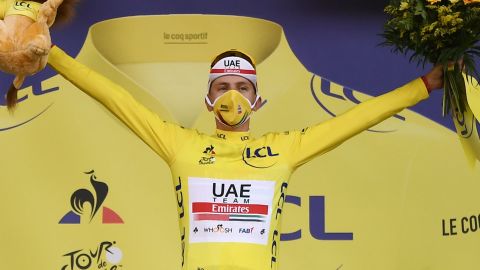 Stage winner Tadej Pogacar proundly dons the yellow jersey on the podium after winning the 20th stage of the 10th edition of the Tour de France. 