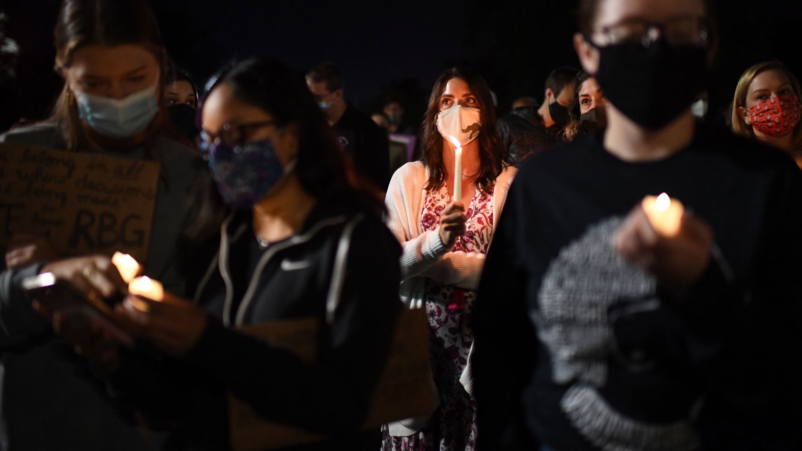 People light candles near the Supreme Court on Saturday, September 19.