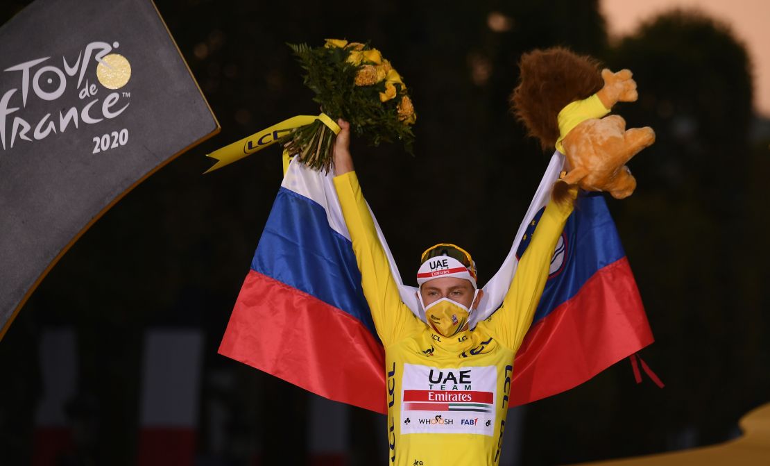 Slovenia's Tadej Pogacar wearing the overall leader's yellow jersey celebrates on the podium after winning the 107th edition of the Tour de France cycling race.
