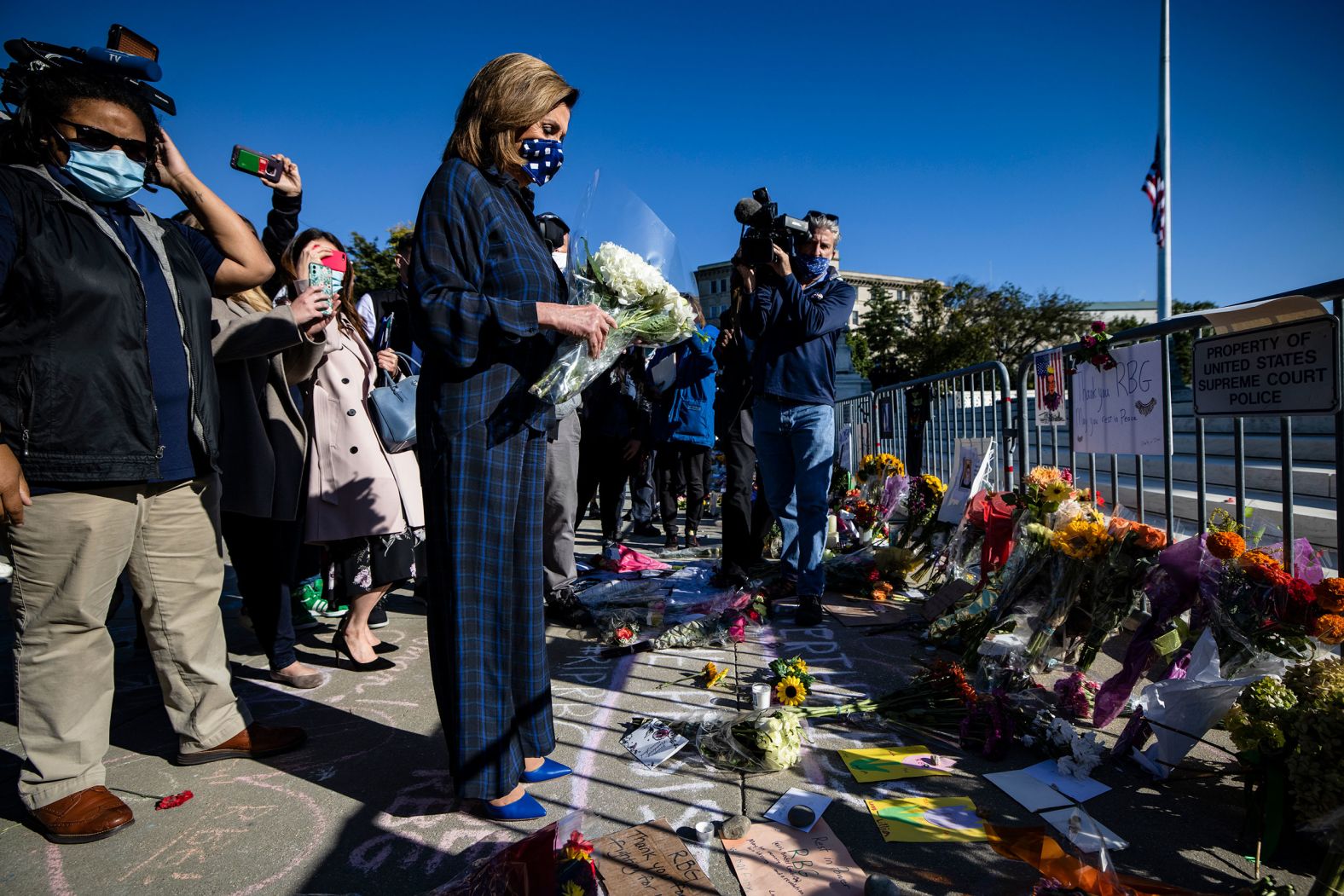 House Speaker Nancy Pelosi arrives to pay her respects at Ginsburg's makeshift memorial in front of the Supreme Court.