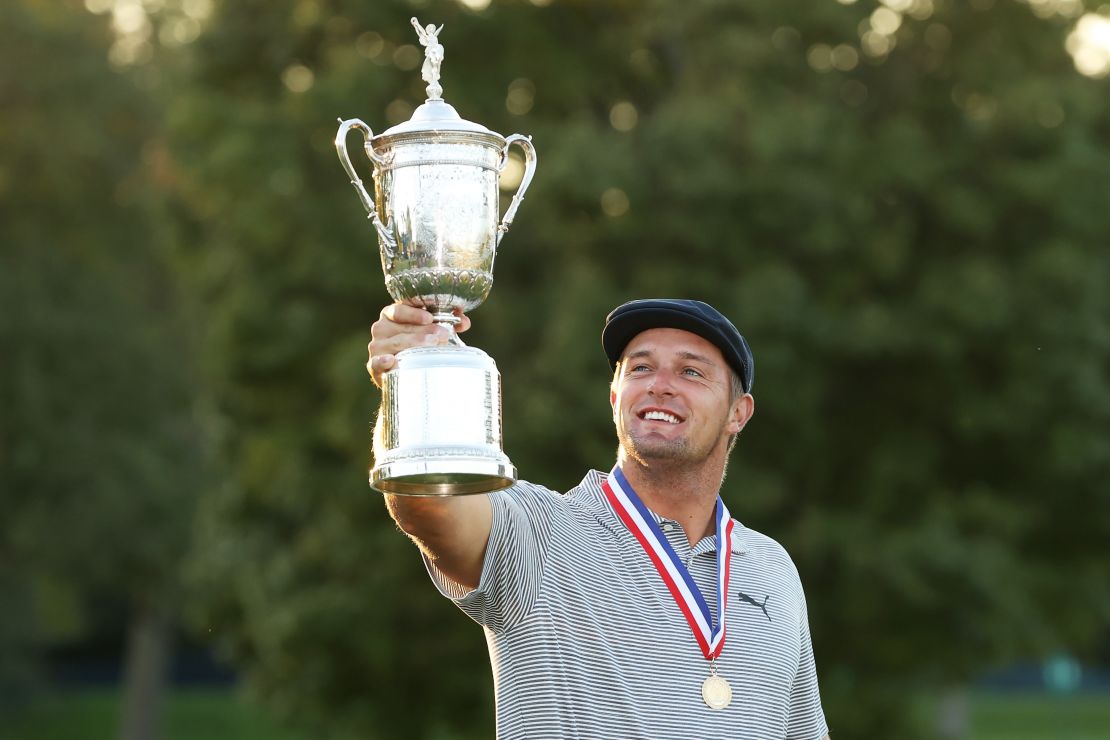 DeChambeau celebrates with the U.S. Open trophy after winning at Winged Foot Golf Club.