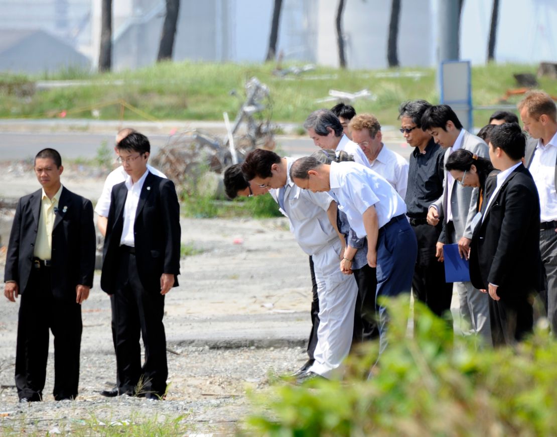 Then UN Secretary-General Ban Ki-moon (sixth from right) and his wife Yoo Soon-taek (third from right) offer prayers for victims of the earthquake and tsunami in Soma city, Japan, in August 2011. 