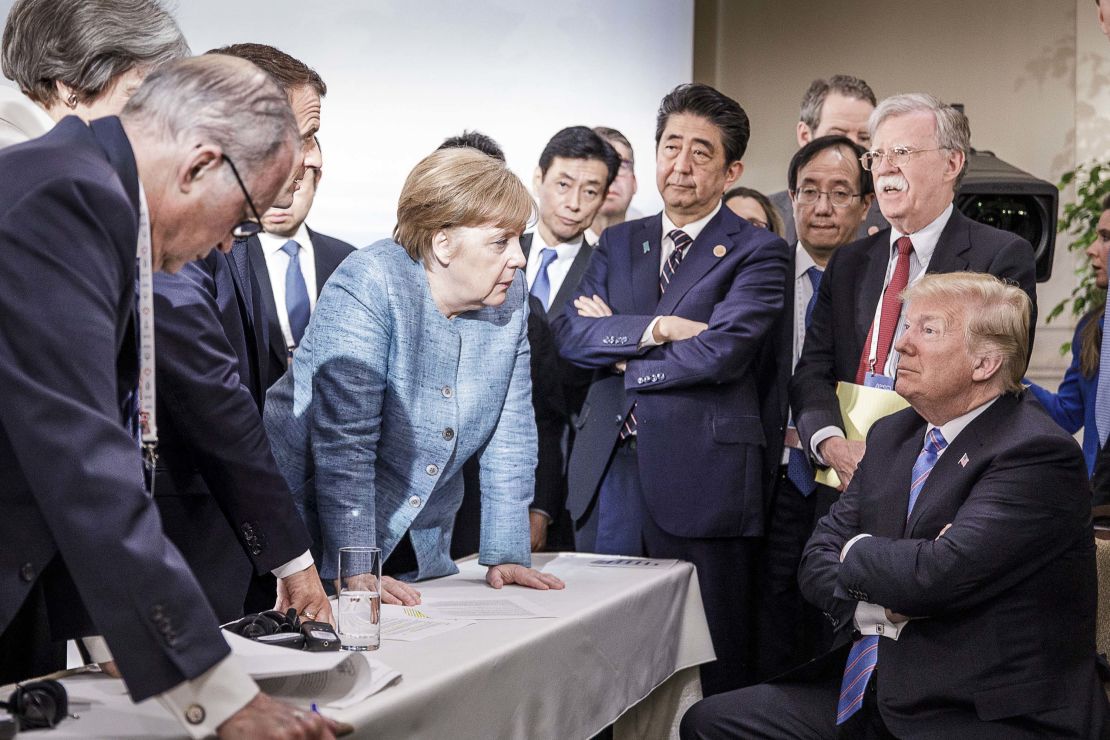 In this photo provided by the German Government Press Office, Merkel deliberates with Trump on the sidelines of the G7 summit in Charlevoix, Canada.