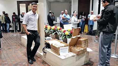 In this November 2018 photo, Pizza to the Polls delivers pizza to voters waiting in line.