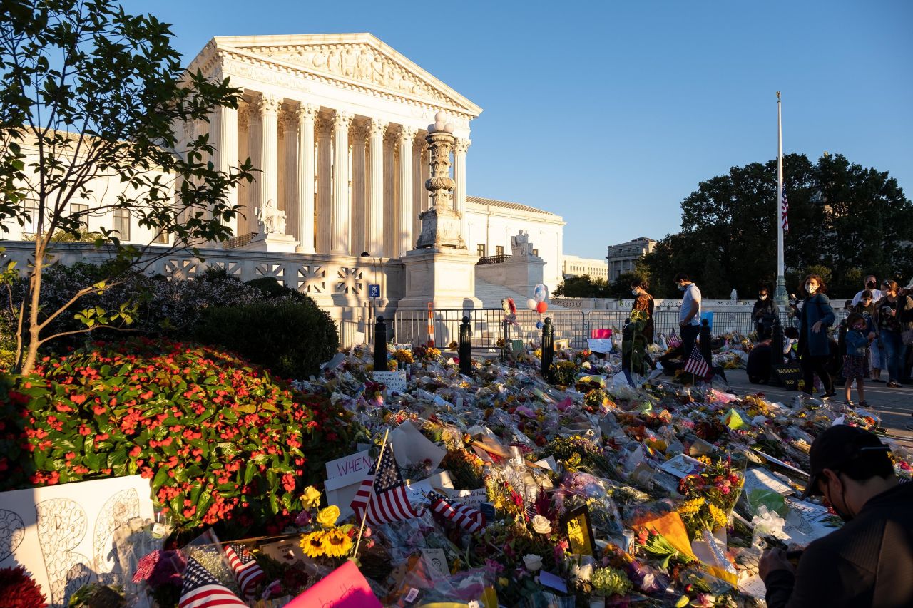 Flowers and notes are left at the makeshift memorial outside of the Supreme Court on September 20.