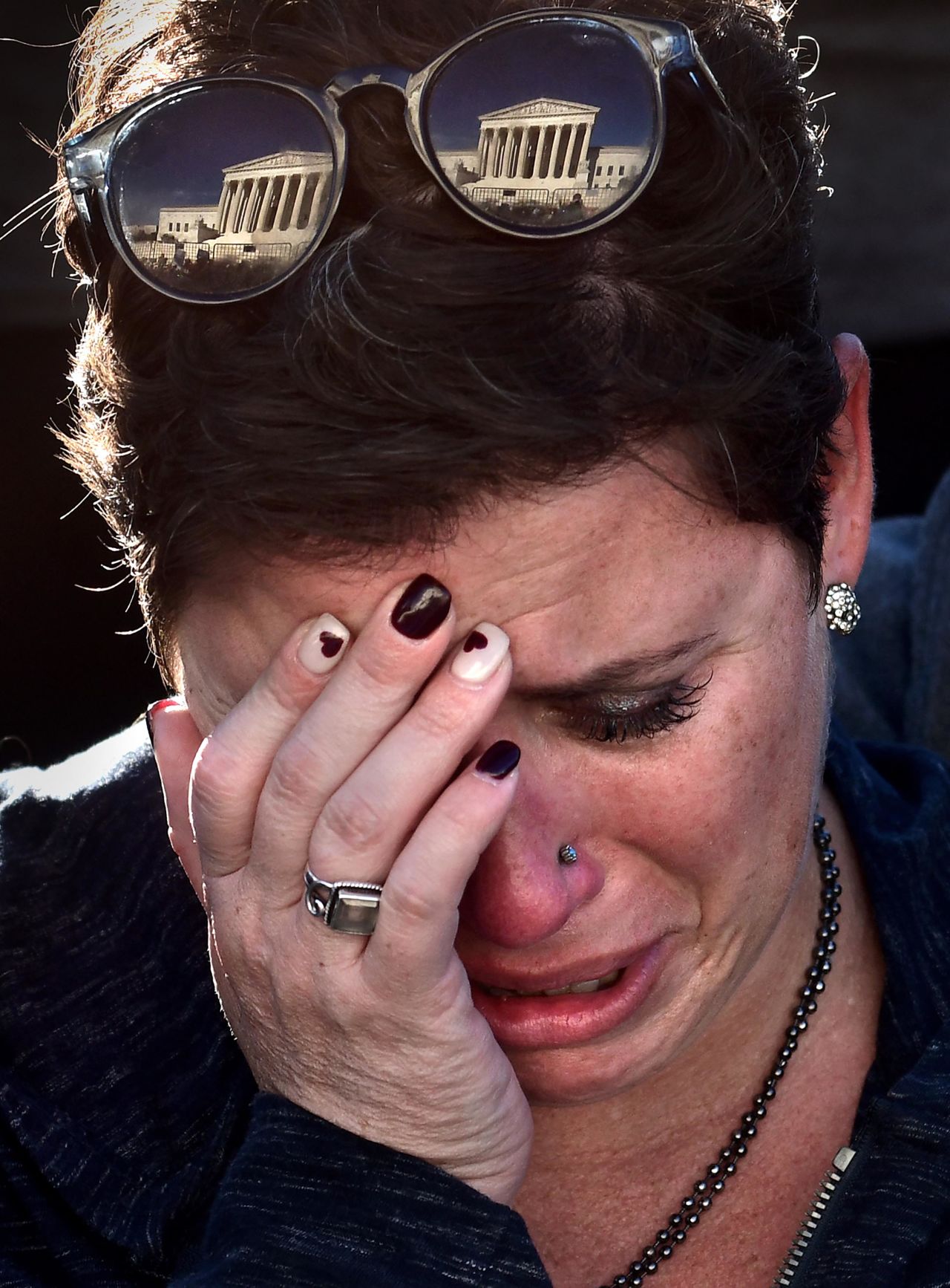 Michele Driesenga weeps during a vigil at the Supreme Court.