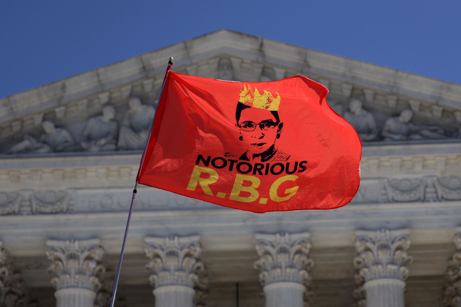 Ginsburg is seen on a flag that someone was waving in front of the Supreme Court on September 21.