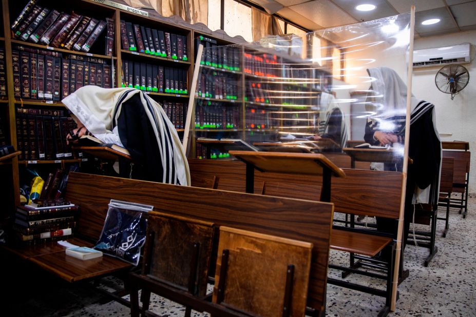 Ultra-Orthodox Jews are separated by plastic shields as they pray in a synagogue in Bnei Brak, Israel, on September 18.