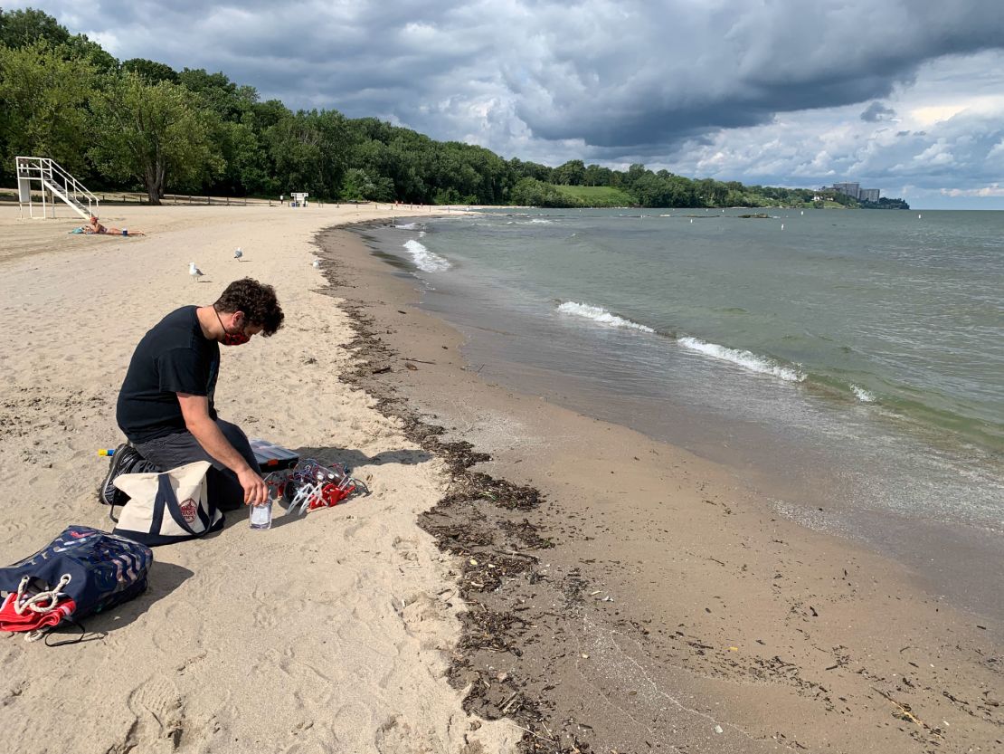 A technician gets ready to test a new robot in the water at Edgewater Beach in Cleveland.