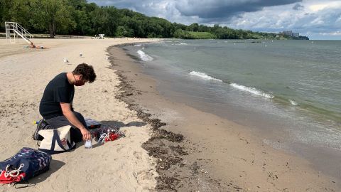 A technician gets ready to test a new robot in the water at Edgewater Beach in Cleveland.
