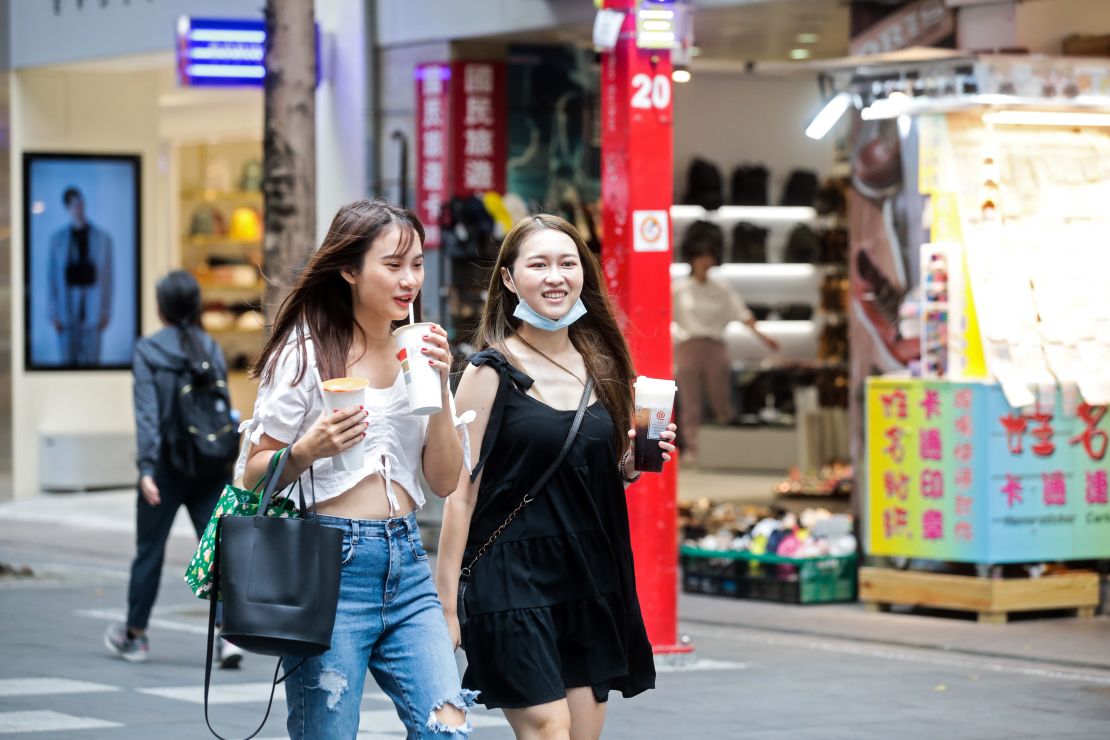 Pedestrians walk with their bubble tea drinks in the Ximending shopping district in Taipei, Taiwan, on July 30, 2020.