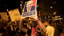 Israeli protesters hold signs and chant slogans during a demonstration against Israeli Prime Minister Benjamin Netanyahu in Jerusalem on September. 20