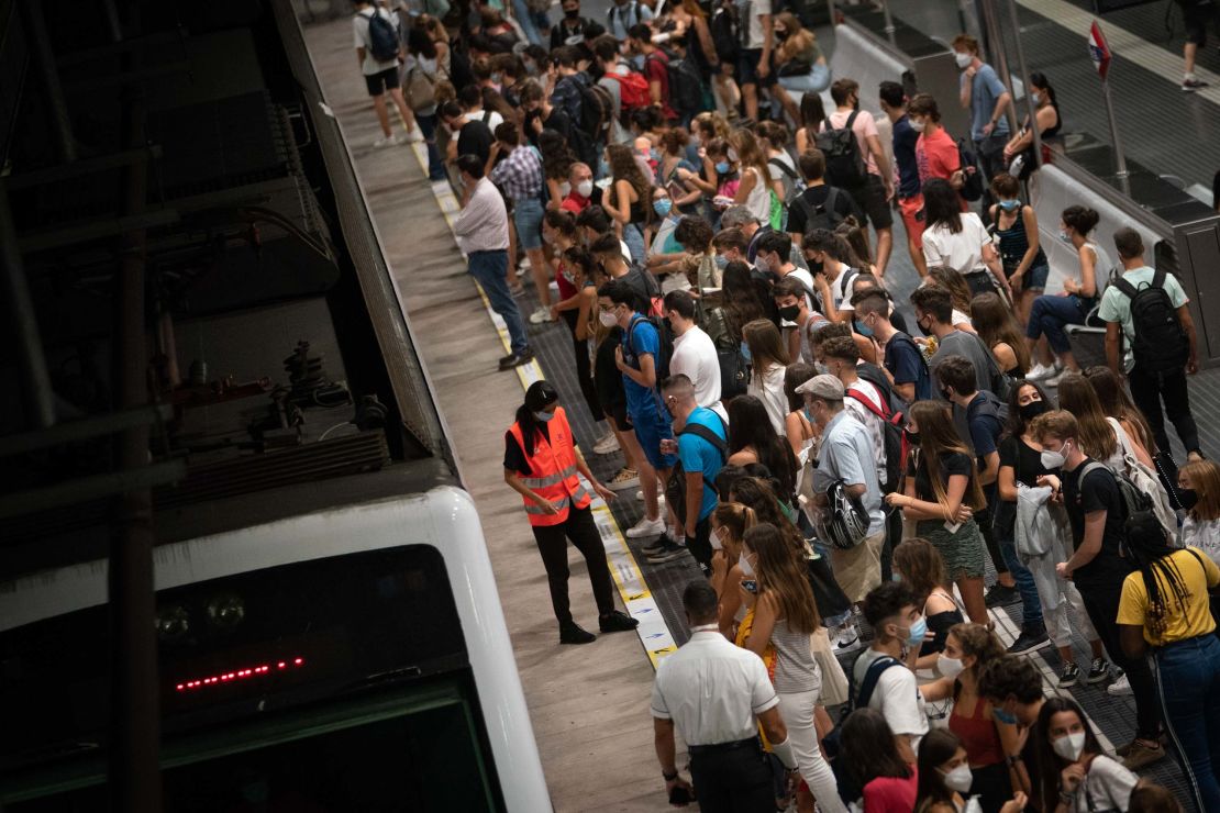 Students wait for a train to university, during rush hour in Barcelona, Spain, on Thursday.