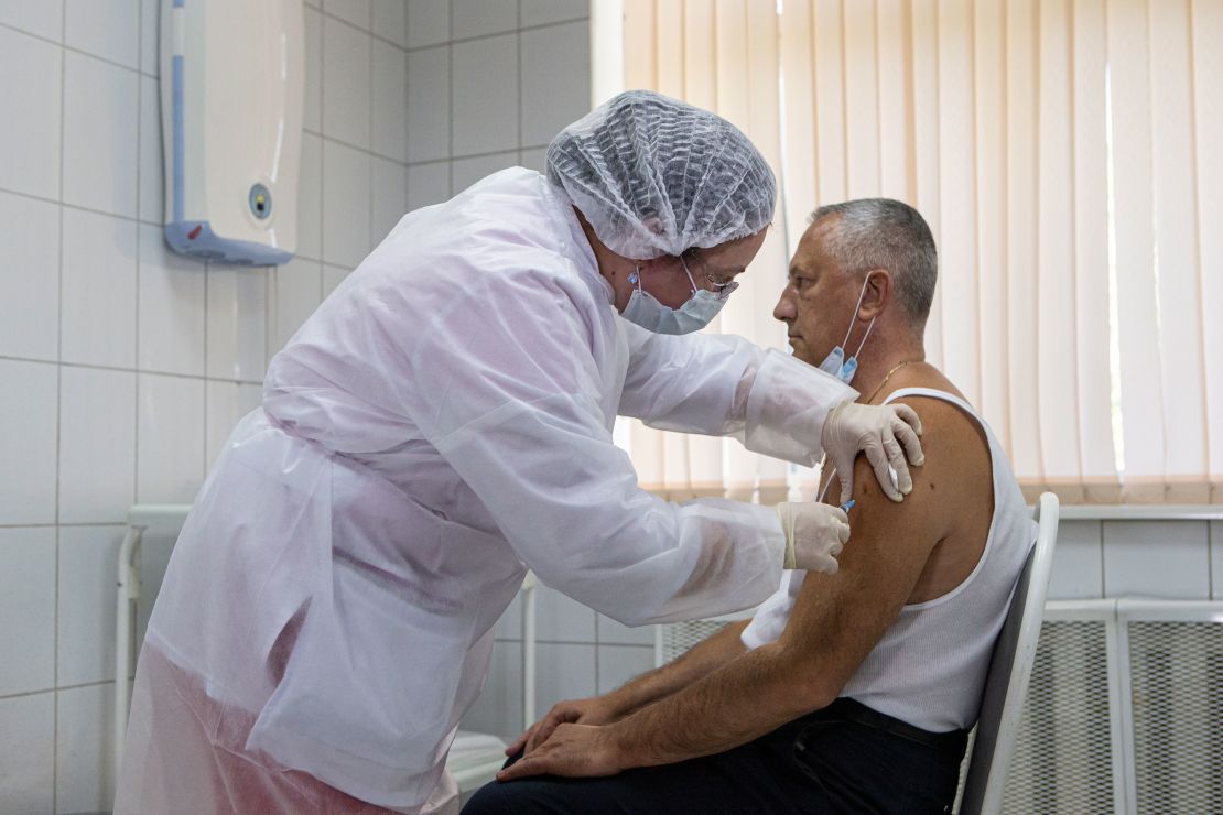 A Russian medical worker adminsters a shot of Russia's experimental Sputnik V coronavirus vaccine in Moscow, on Sept. 15, 2020.