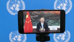 Chinese President Xi Jinping is seen on a phone screen remotely addressing the 75th session of the United Nations General Assembly, Tuesday, Sept. 22, 2020, at U.N. headquarters. This year's annual gathering of world leaders at U.N. headquarters will be almost entirely "virtual." Leaders have been asked to pre-record their speeches, which will be shown in the General Assembly chamber, where each of the 193 U.N. member nations are allowed to have one diplomat present. (AP Photo/Mary Altaffer)