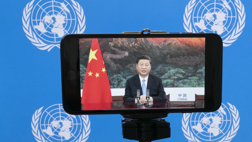 Chinese President Xi Jinping is seen on a phone screen remotely addressing the 75th session of the United Nations General Assembly, Tuesday, Sept. 22, 2020, at U.N. headquarters. This year's annual gathering of world leaders at U.N. headquarters will be almost entirely "virtual." Leaders have been asked to pre-record their speeches, which will be shown in the General Assembly chamber, where each of the 193 U.N. member nations are allowed to have one diplomat present. (AP Photo/Mary Altaffer)