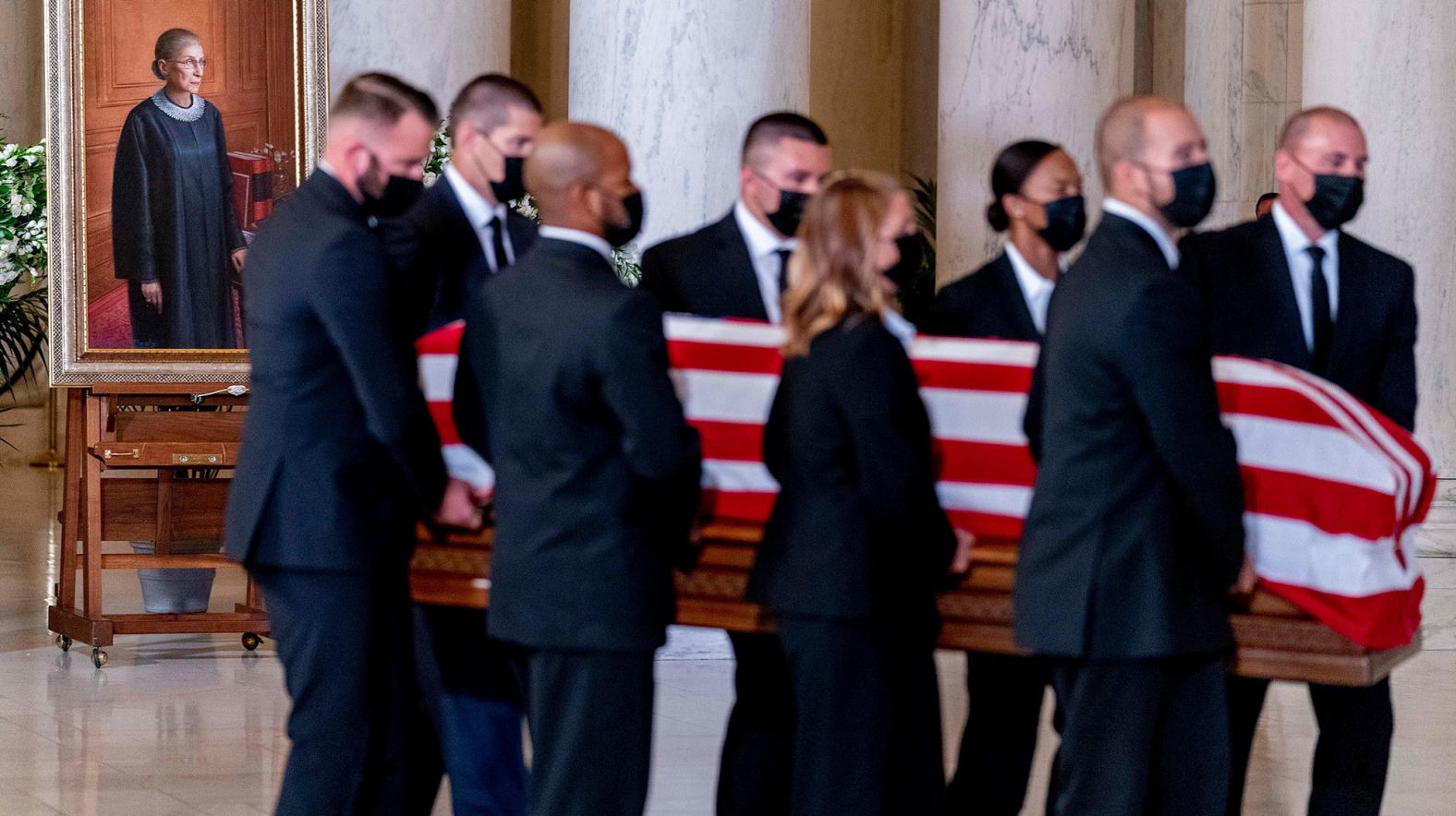 The flag-draped casket of Justice Ruth Bader Ginsburg is carried through the Great Hall at the Supreme Court in Washington.