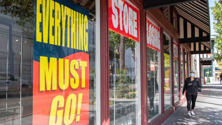 "Store Closing" signs are posted at a "Sur La Table" kitchenware store as people walk by on September 22, 2020, in Los Angeles, California. (Photo by Valerie Macon/AFP/Getty Images)