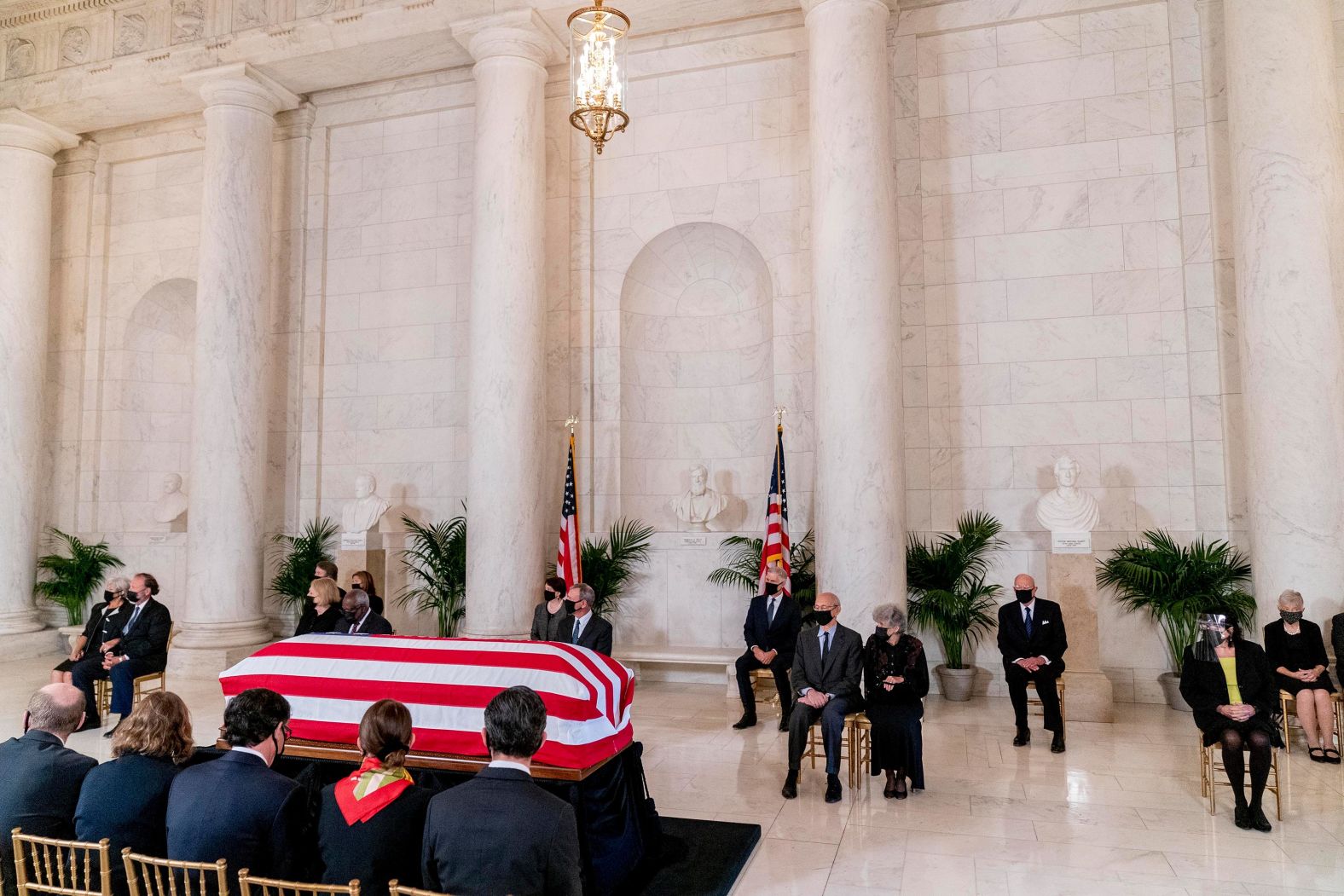 The Supreme Court justices and their spouses sit in front of the casket during a private ceremony Wednesday.