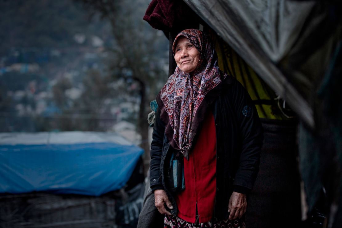 A woman stands outside her tent in the Moria refugee camp in Lesbos, Greece in February 2020. 