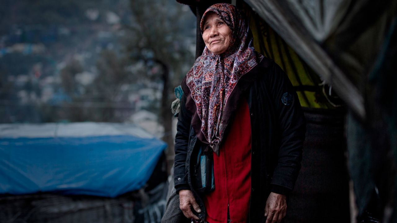A woman stands outside her tent in the Moria refugee camp in Lesbos, Greece in February 2020.