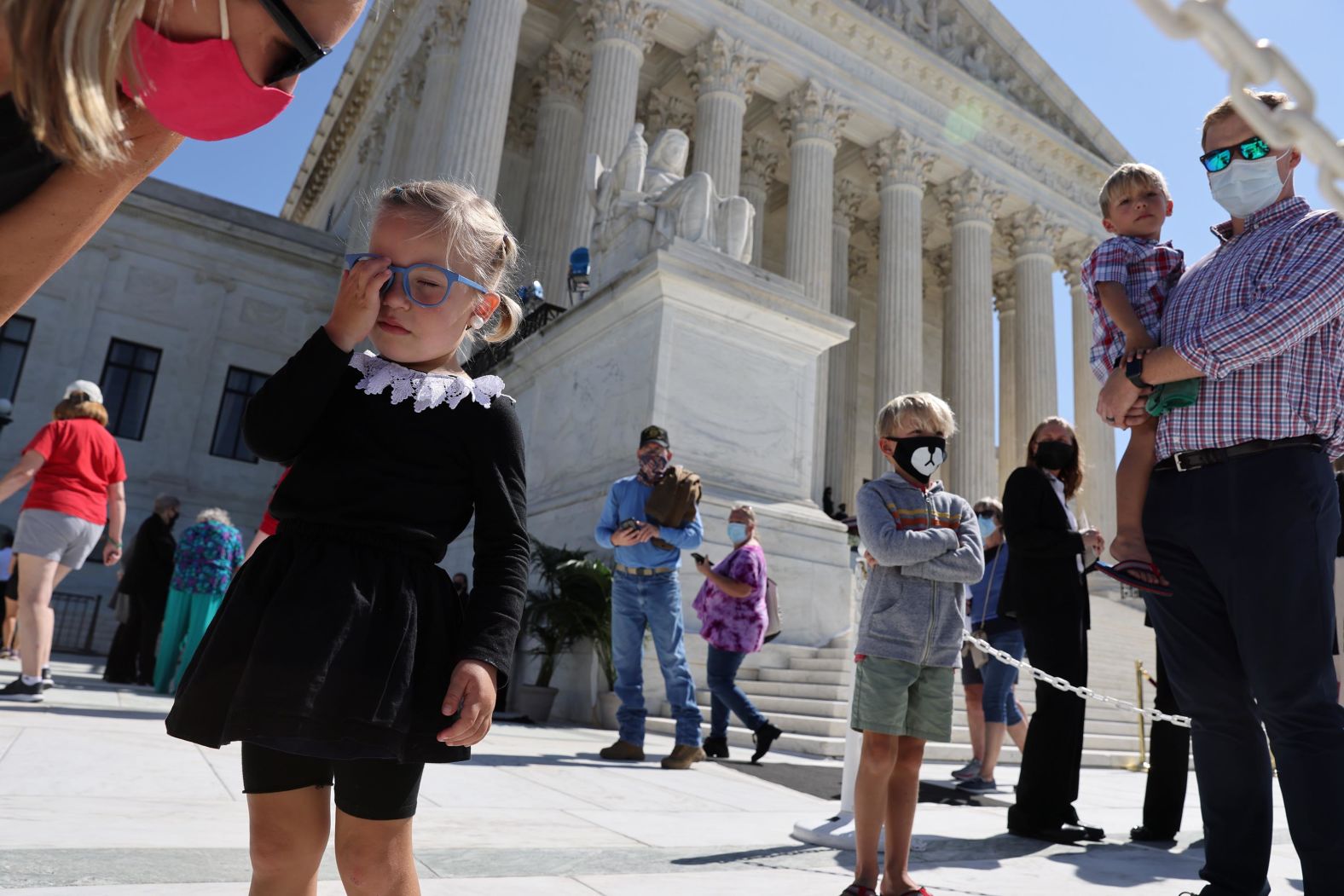 Lucille Wilson, 3, stands outside the Supreme Court dressed as Justice Ginsburg.
