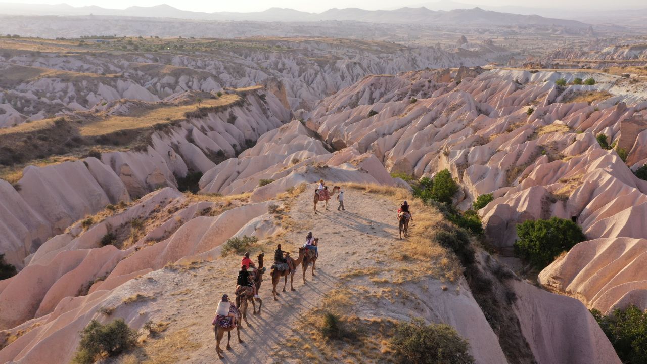 <strong>Cappadocia, Turkey: </strong>A tour group rides camels through Central Anatolia's Cappadocia region, a UNESCO World Heritage site famed for its chimney rocks, hot air balloon trips, underground cities and boutique hotels carved into rocks. 