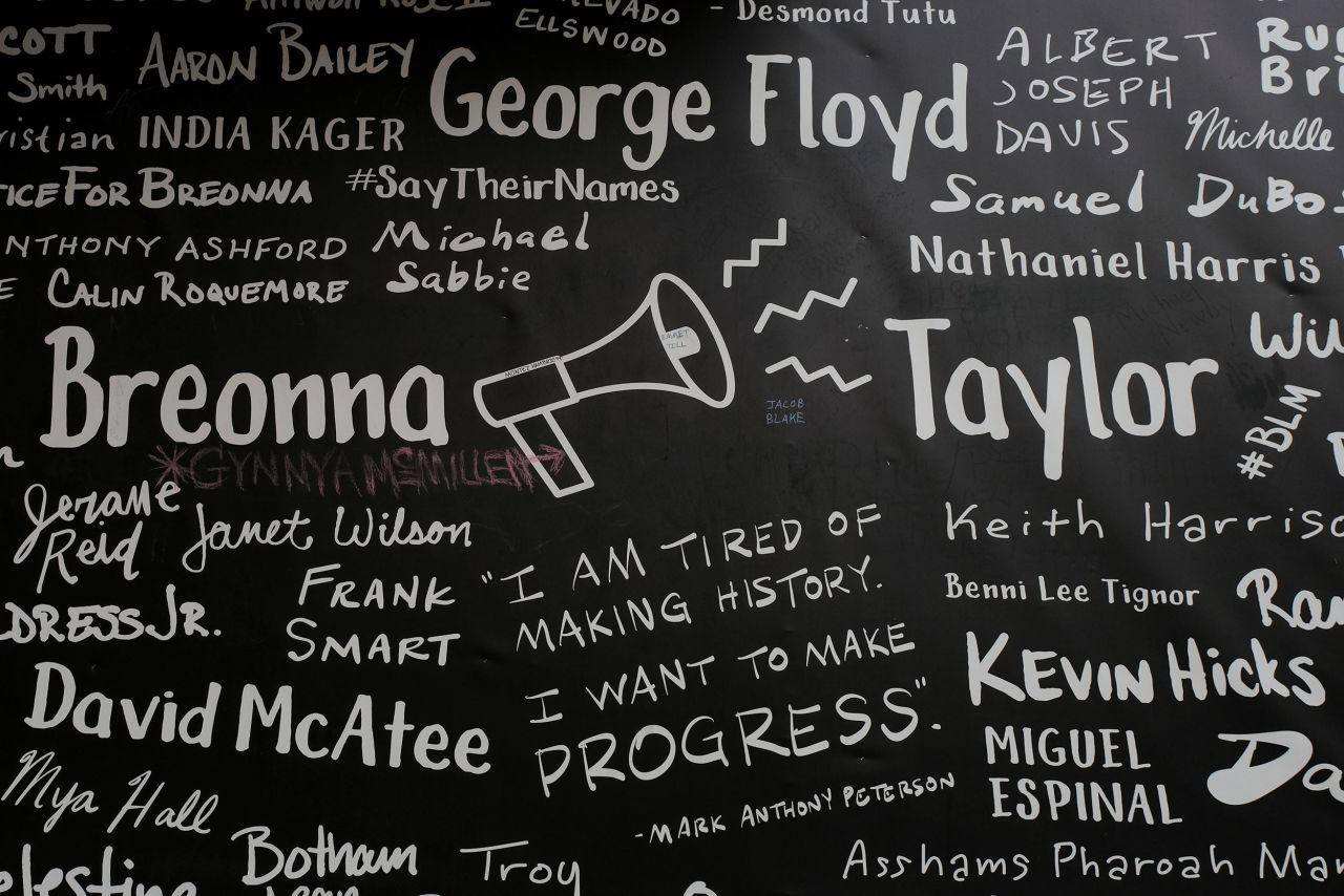 Names of victims of police shootings are seen on a boarded-up business in downtown Louisville.