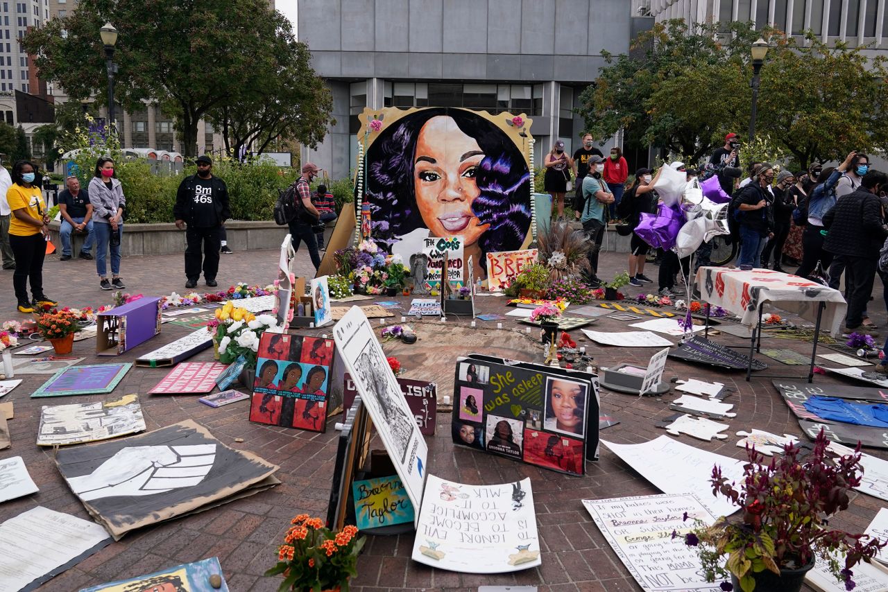 People covered Jefferson Square in Louisville with signs and flowers memorializing Taylor while waiting for the announcement in her case.