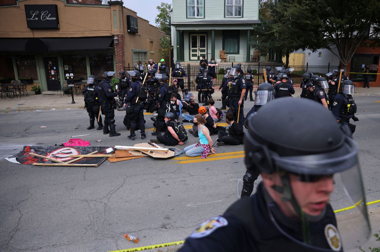 Louisville officers detain protesters following the announcement.