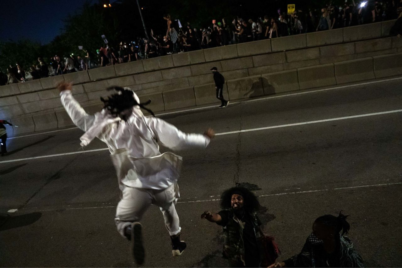 Protesters jump onto the lower roadway of the Manhattan Bridge as people demonstrate in New York.