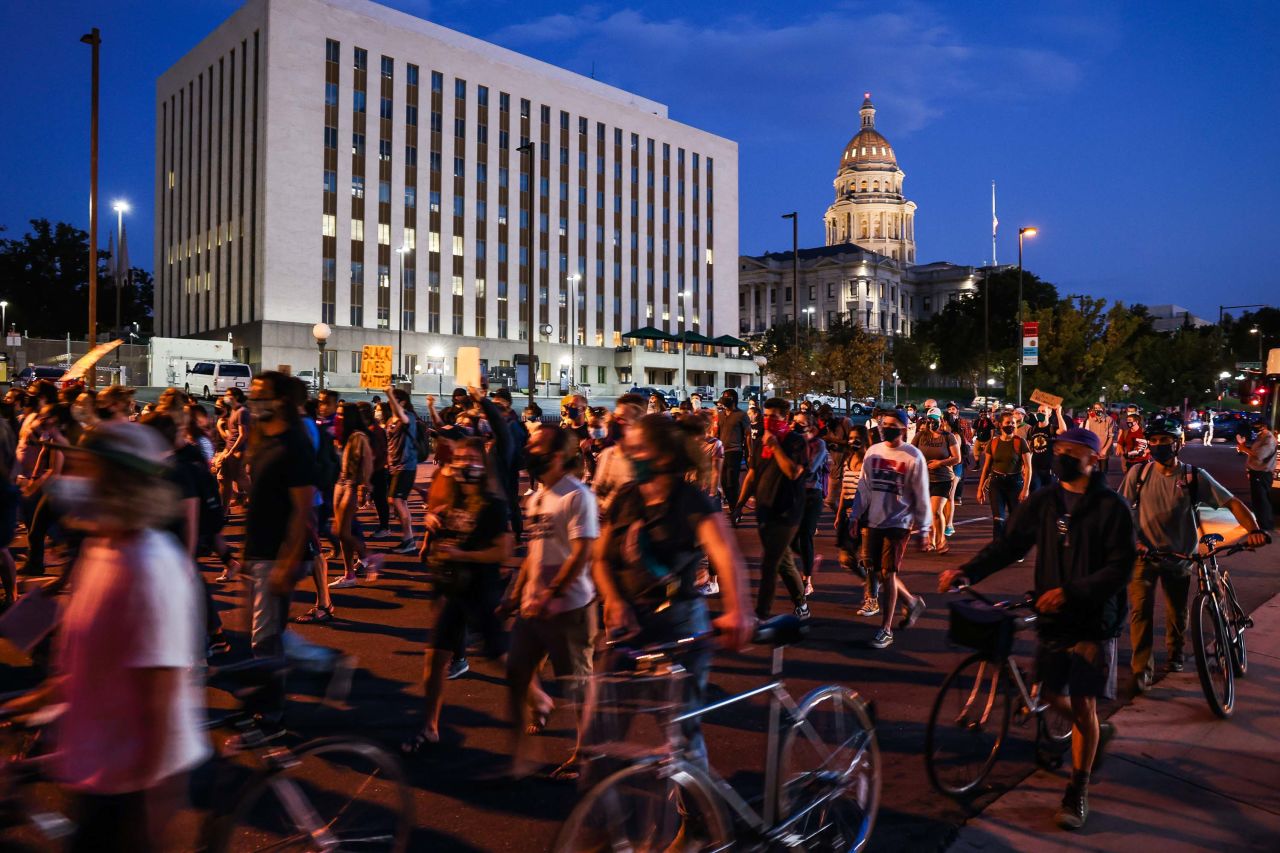 People rally in Denver to protest the grand jury decision.