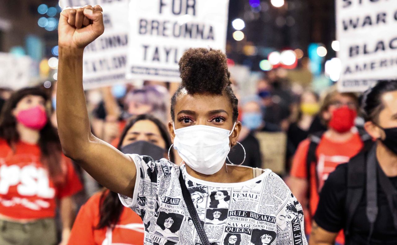 Sheree Barbour holds her fist in the air as people protest the grand jury decision in the Breonna Taylor case on Wednesday, September 23, in Denver, Colorado.