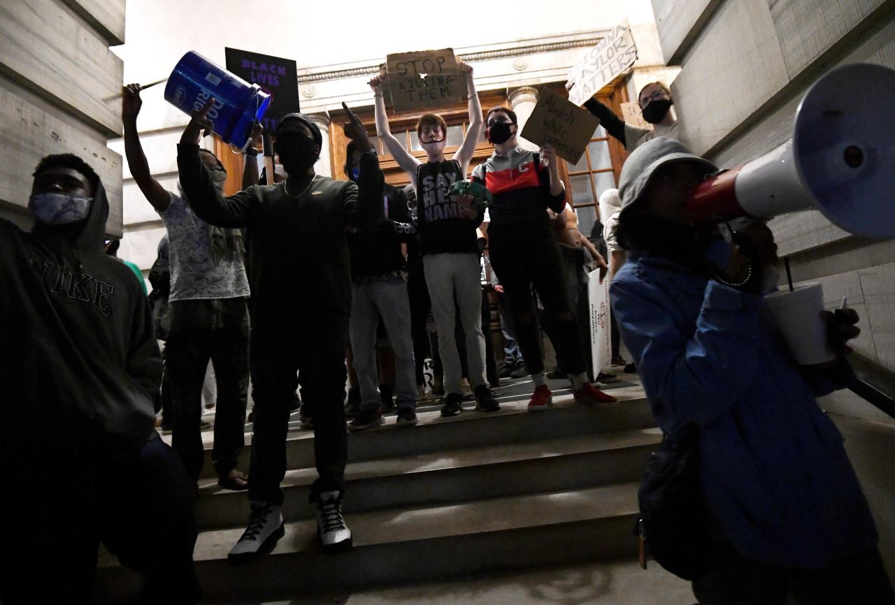 Protesters demonstrate at the door to the Tennessee State Capitol in Nashville.