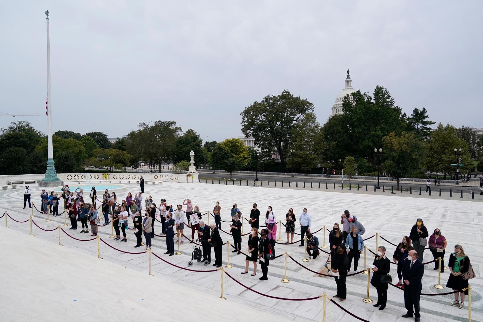 Mourners line up outside the Supreme Court on Thursday.