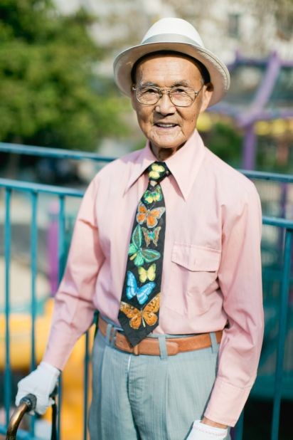 Buck Chew, who moved to the US in 1983, sports a fedora, suit, white gloves and a colorful tie.