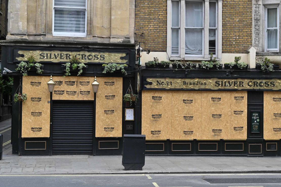 The boarded-up windows of The Silver Cross pub in London, pictured in May.