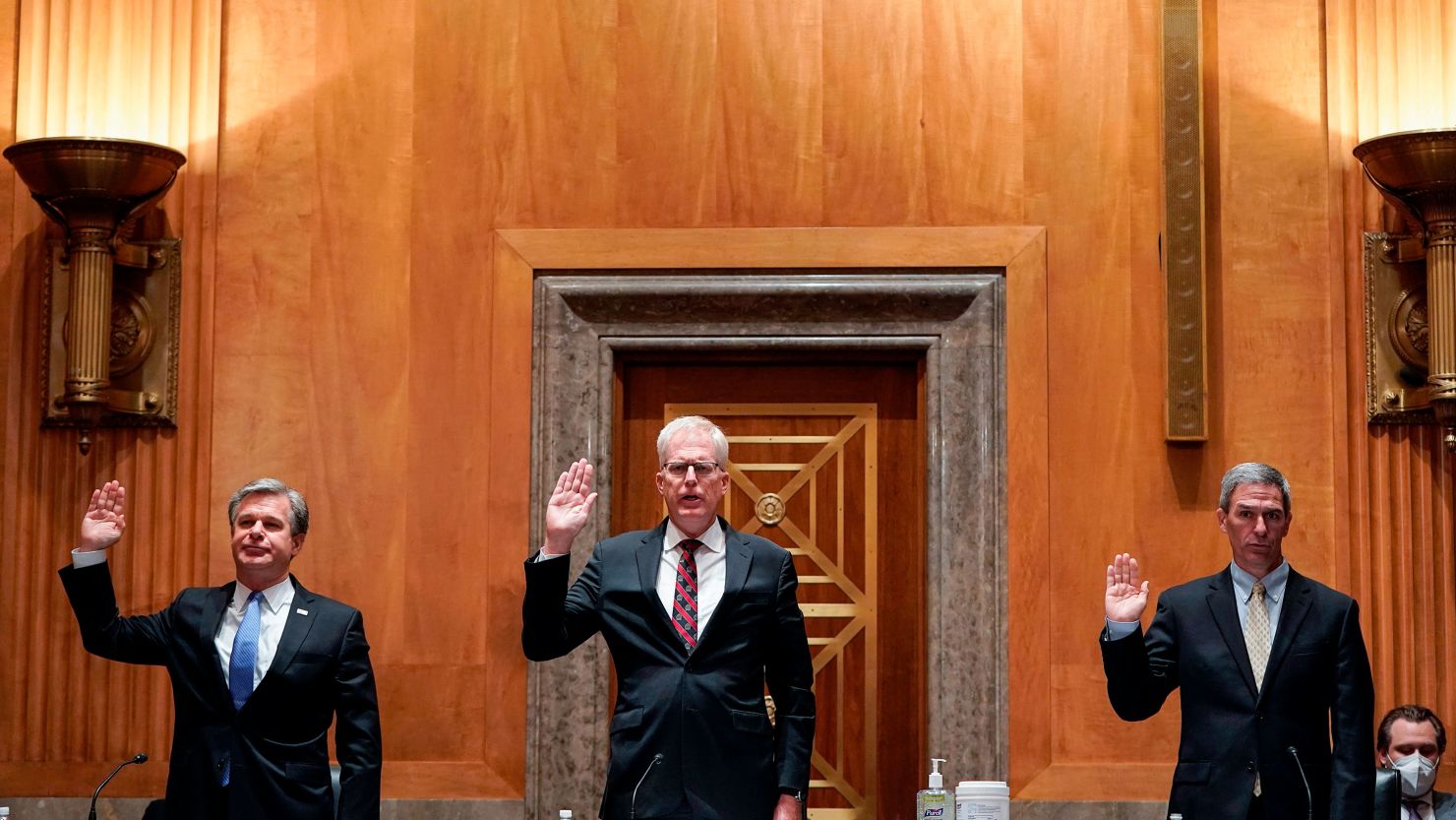 FBI Director Christopher Wray; National Counterterrorism Center Director Christopher Miller and Deputy Homeland Security Secretary Ken Cuccinelli are sworn in before a Senate Homeland Security and Governmental Affairs Committee hearing on "Threats to the Homeland" on Thursday. 